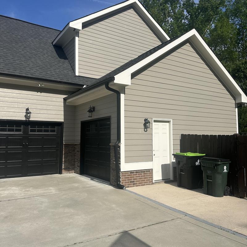 Garage roof line raising with siding and gutters