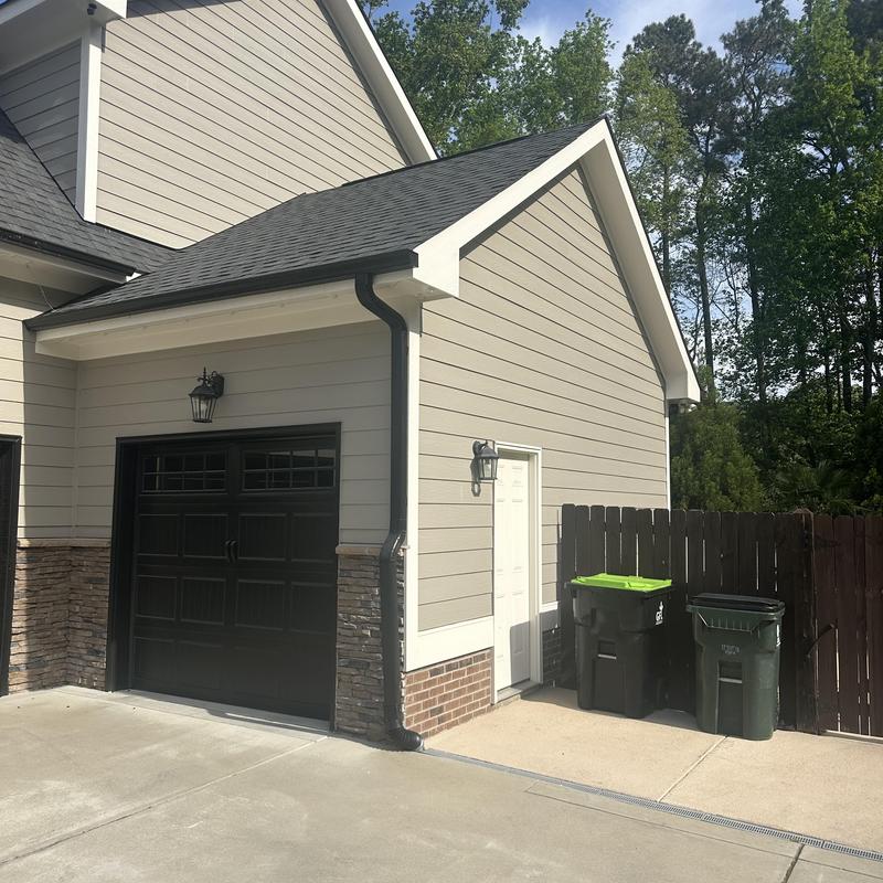 Garage roof line raised with new siding and trim