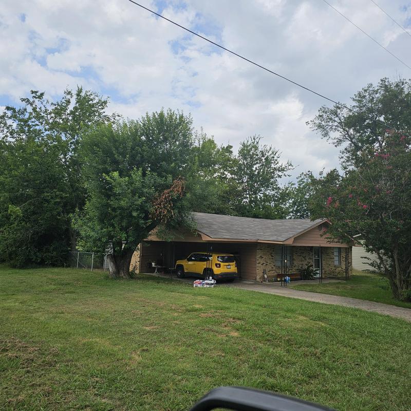 Asphalt shingle roof with hail damage on residential house