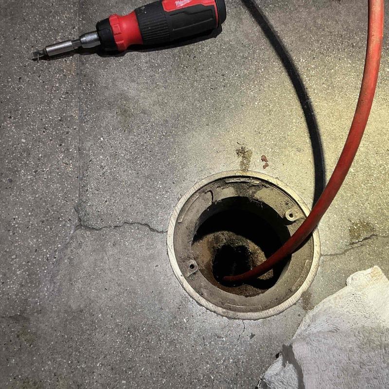 Floor drain system cleaning with power tool and hose