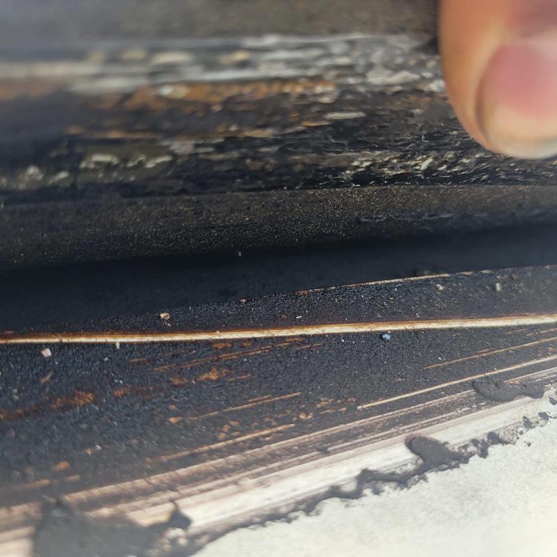 Roof deck showing soft spots and damaged shingles