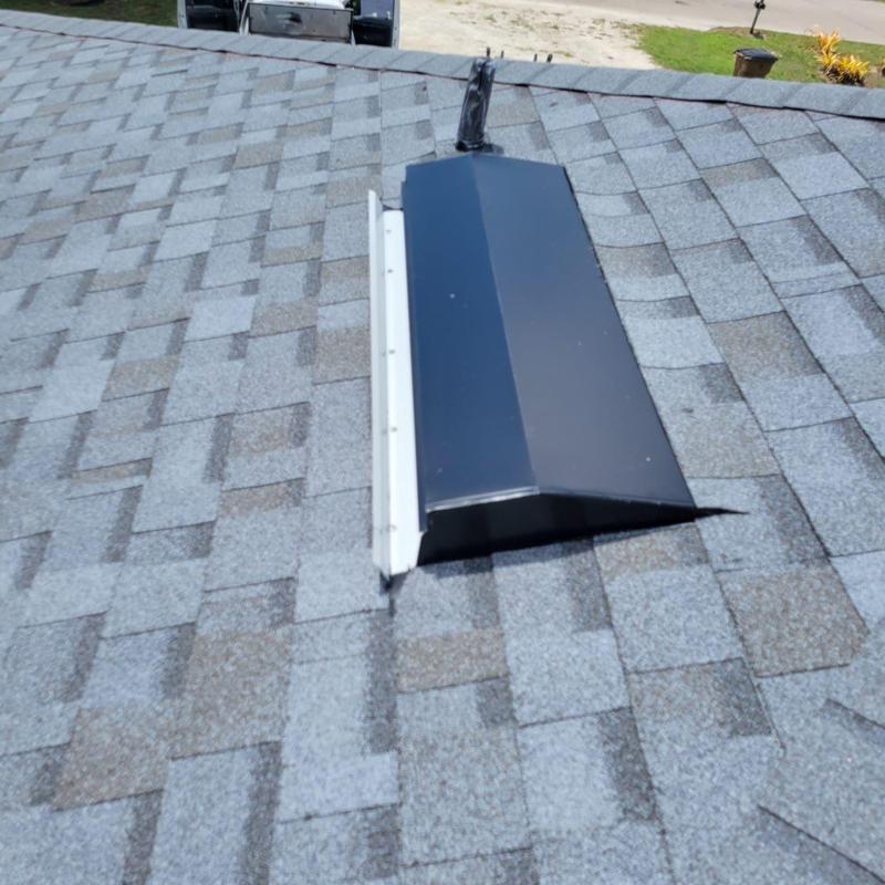 Roof ridge vent installation on asphalt shingle roof