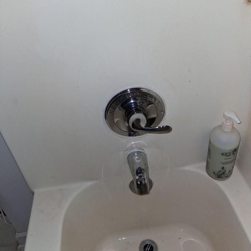 Shower valve and tub spout in bathroom tub