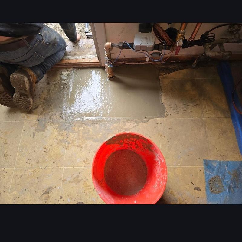 Water service line installation with fresh concrete patch