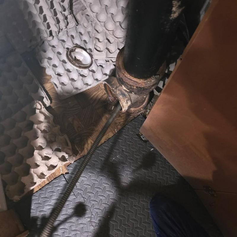 Basement drain pipe with drain cleaning cable inserted