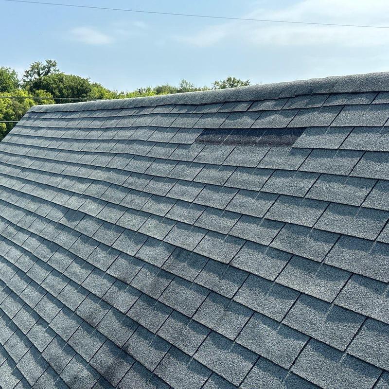 Asphalt roof shingles with hail damage and granule loss