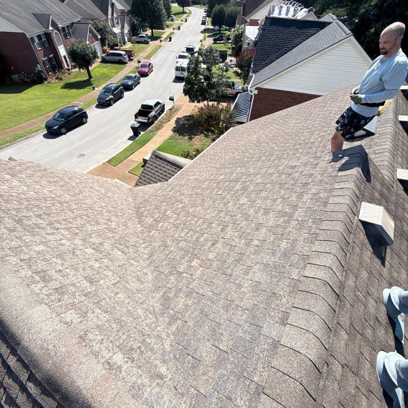 Roof shingles with hail damage inspection on residential roof