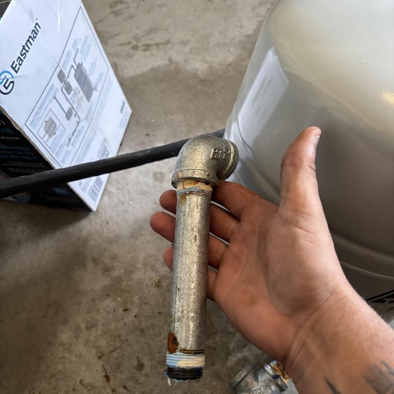 Galvanized pipe with corrosion near water heater expansion tank