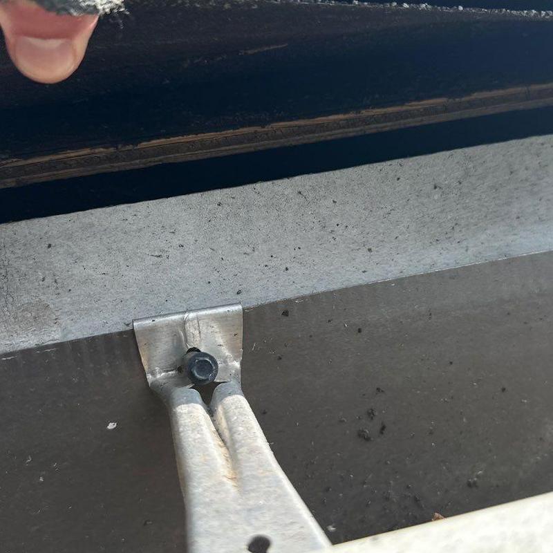 Metal roof flashing with bolt and sealant inspection