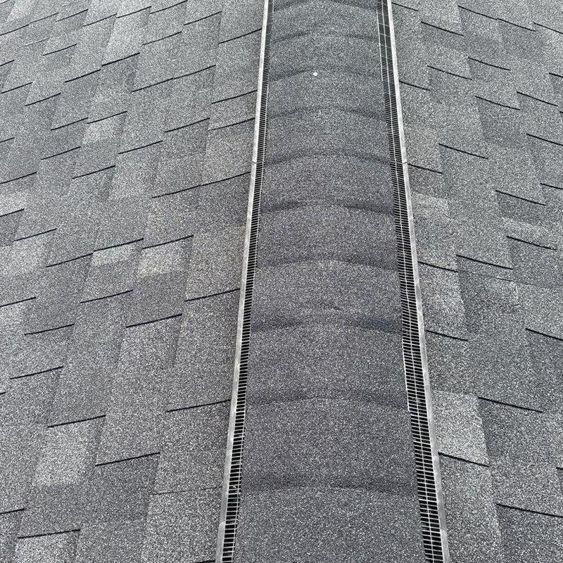 Roof shingles and ridge vent with hail damage