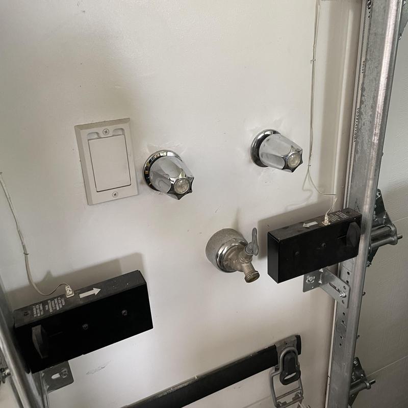 Garage utility sink faucet and valve connections on wall