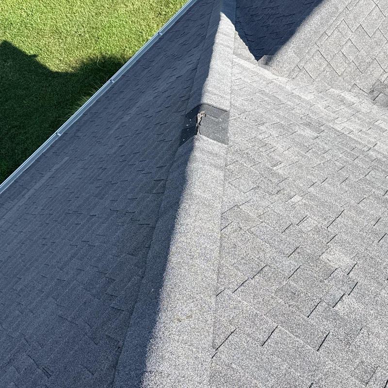 Roof shingles with hail damage on ridge line