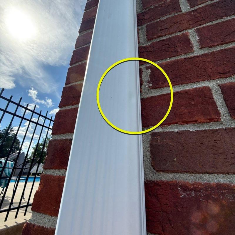 Downspout dent with yellow inspection marker