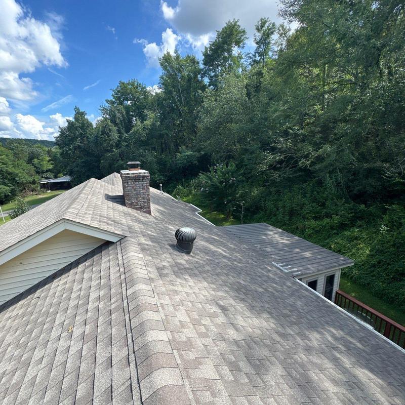 Asphalt shingle roof with ridge vent and chimney