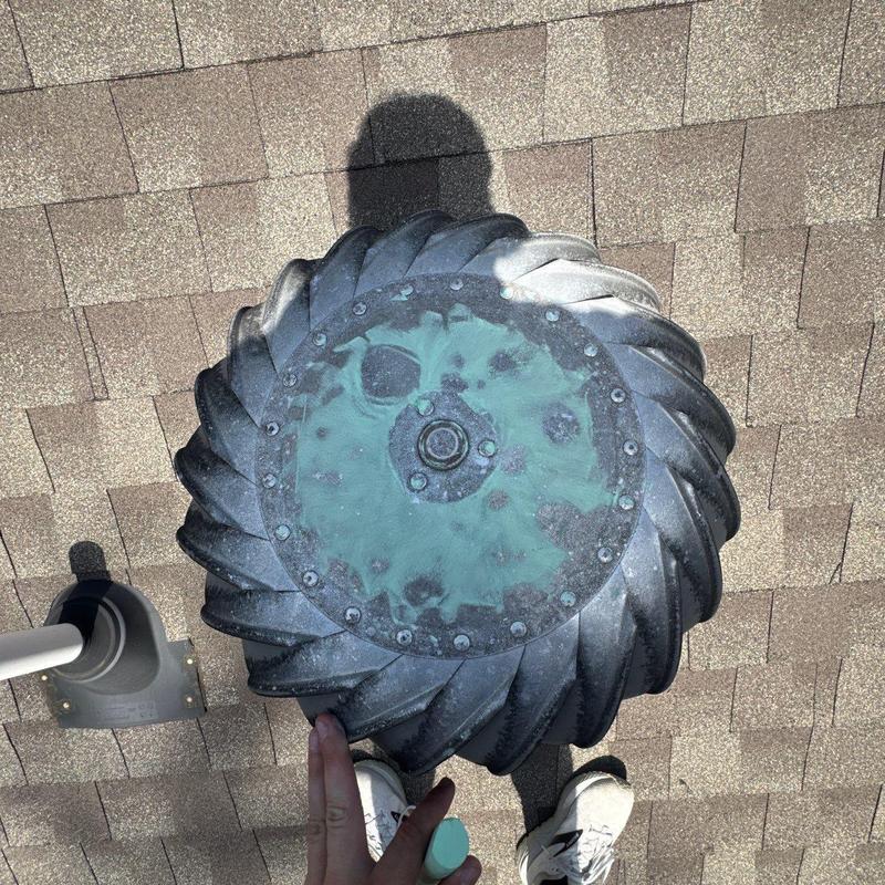 Turbine roof vent with corrosion on shingles