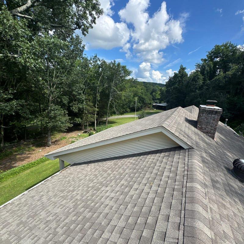 Asphalt shingle roof inspection with hail damage visible