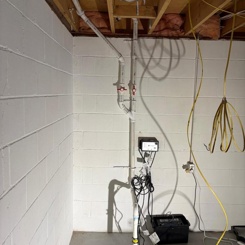 Sump discharge piping with shutoff valves in basement