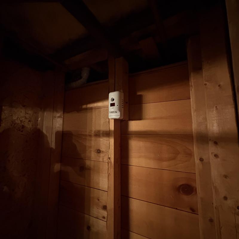 Carbon monoxide detector installed on wooden wall studs