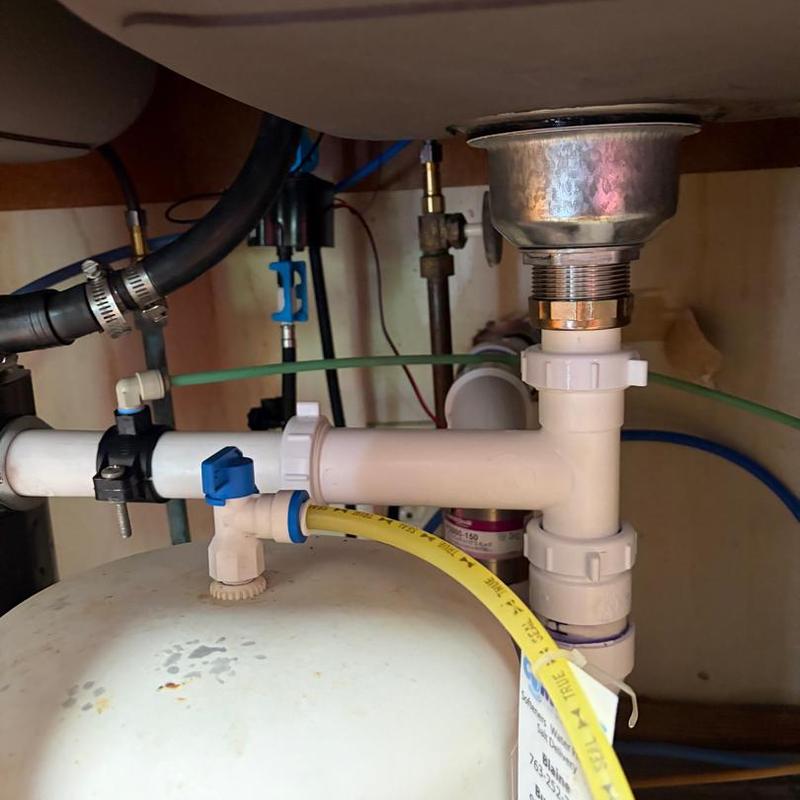 Kitchen sink drain pipes and fittings under cabinet