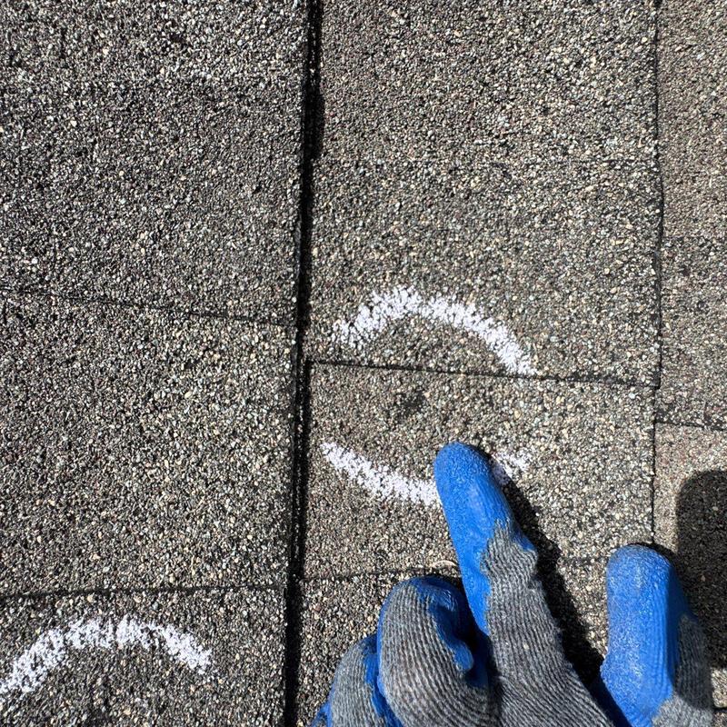 Roof shingles with hail damage marked during inspection