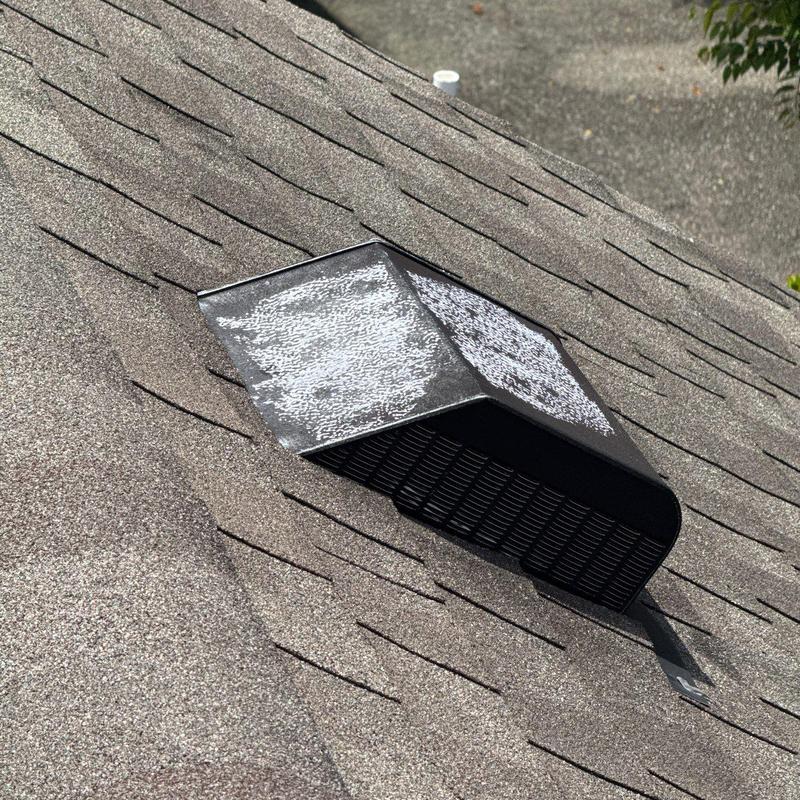 Roof vent with hail damage on asphalt shingles