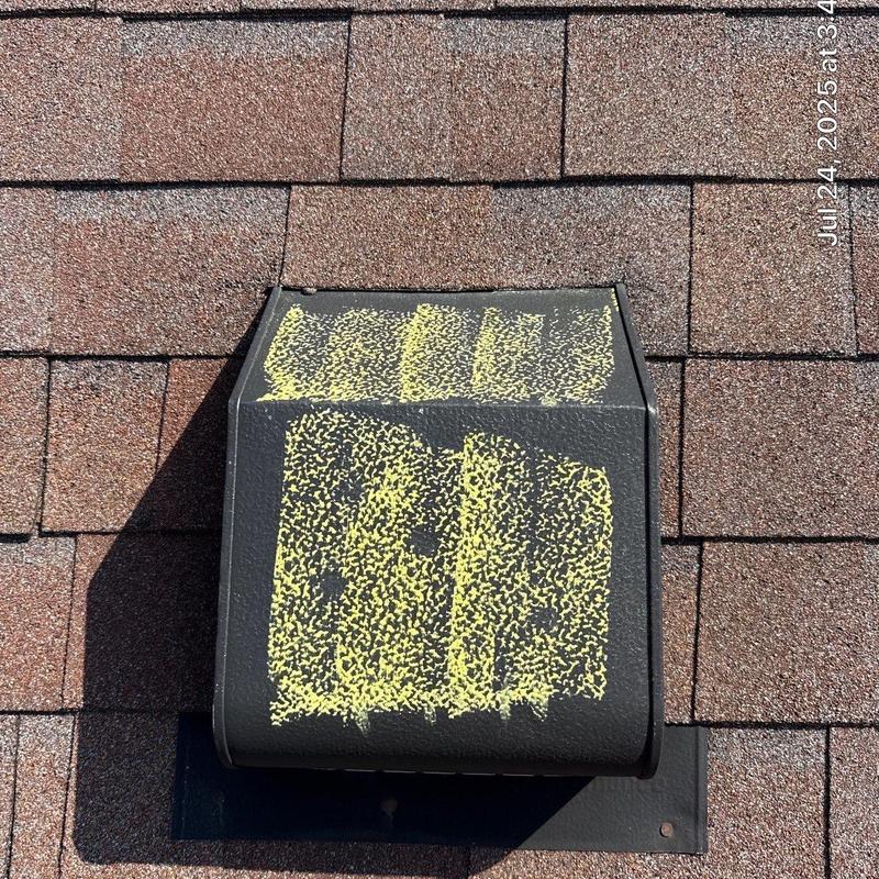 Roof vent with hail damage markings on shingles