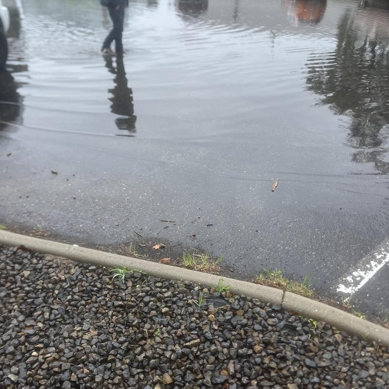 Parking lot stormwater flooding with standing water Parking lot stormwater flooding with standing water