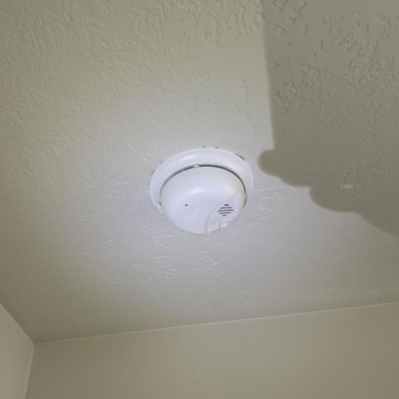 Hardwired smoke detector installed on ceiling