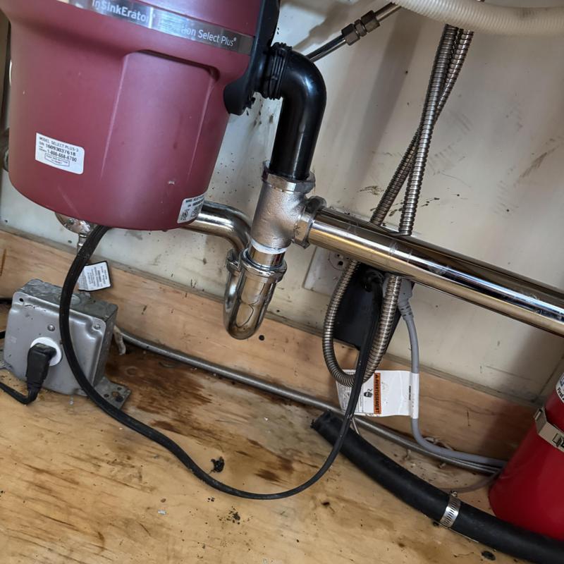 Garbage disposal with connected drainage pipes under sink