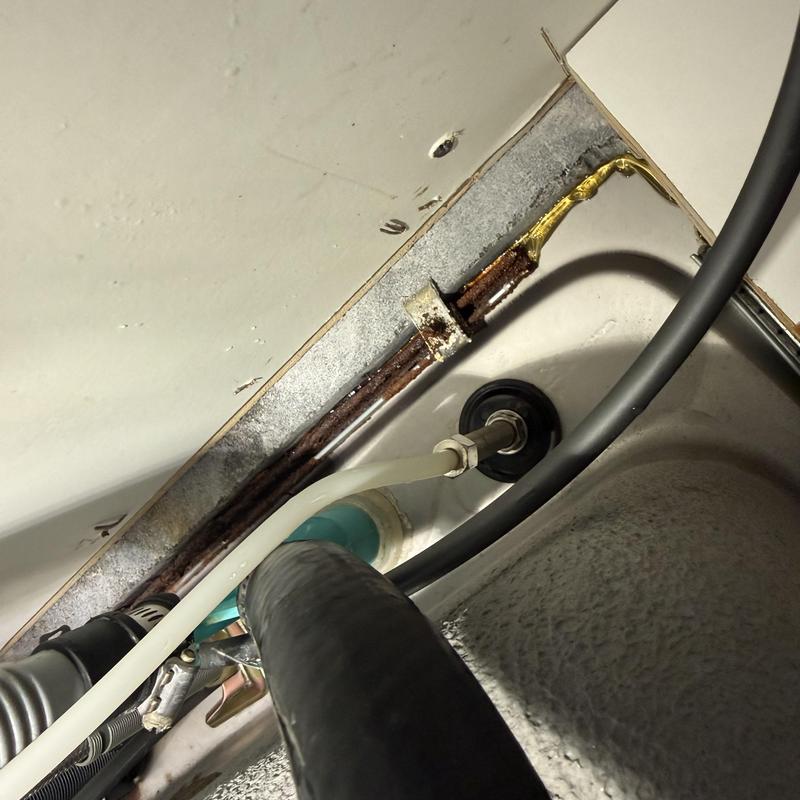 Water filter supply line and angle stop under kitchen sink