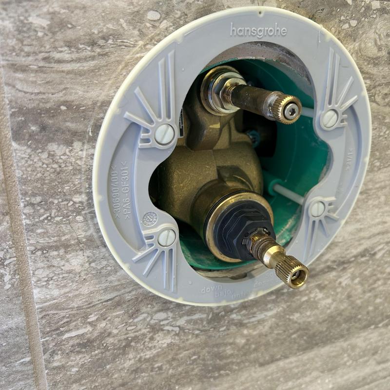 Shower cartridge valve installation on tiled wall