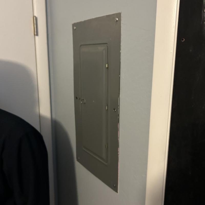 Electrical panel box with closed gray metal door