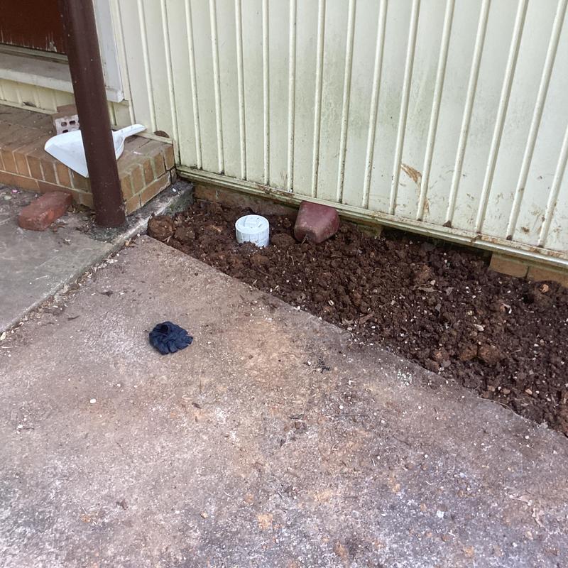 Cast iron drain with two-way clean out installed in yard