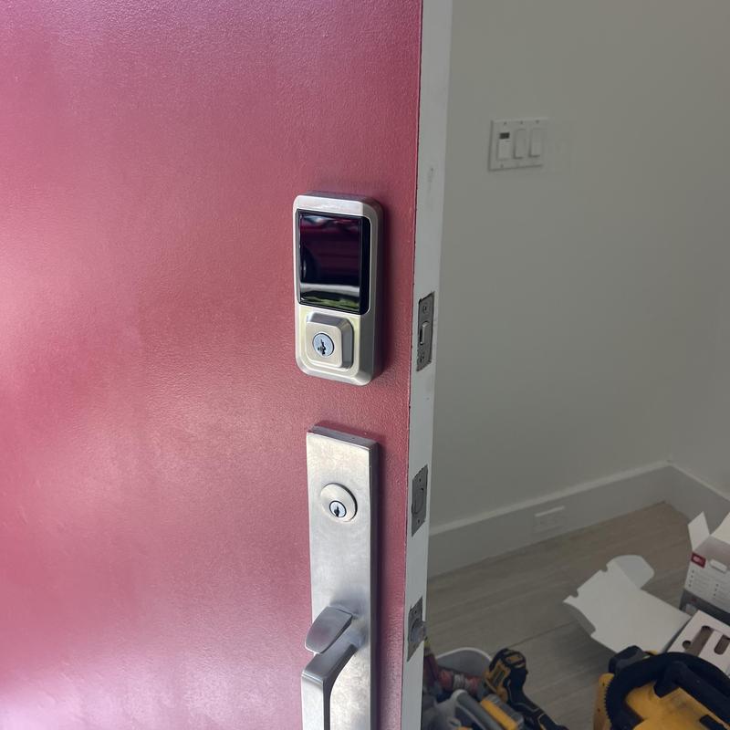 Keypad smart lock installation on red exterior door