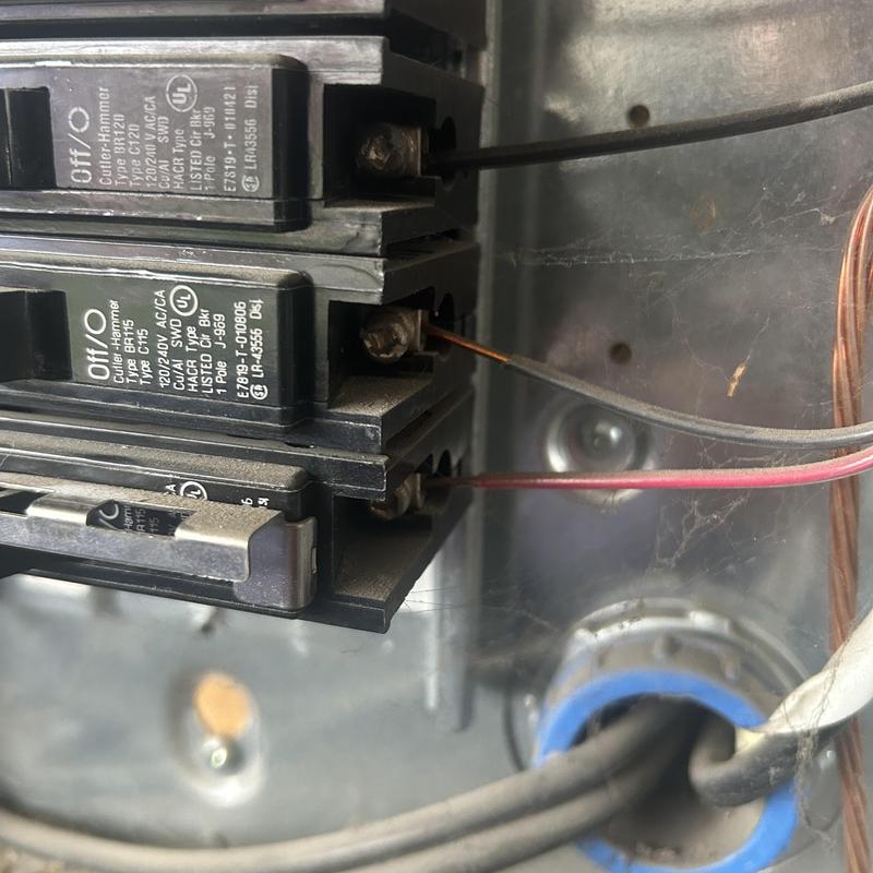 Main service panel breakers with exposed copper wiring