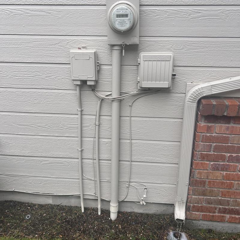 Electric meter and service panel on house exterior