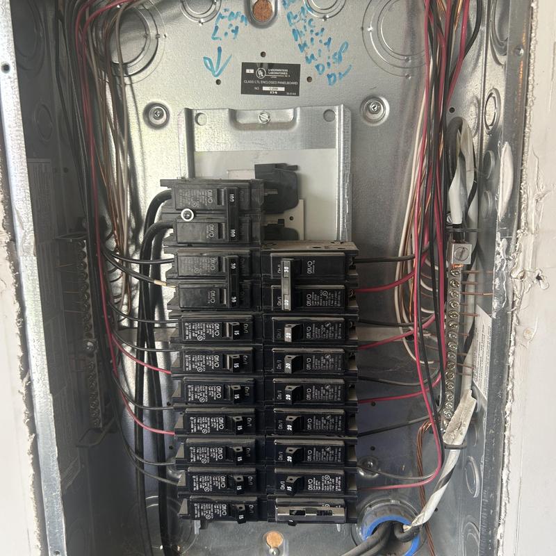 Main electrical panel with circuit breakers and wiring