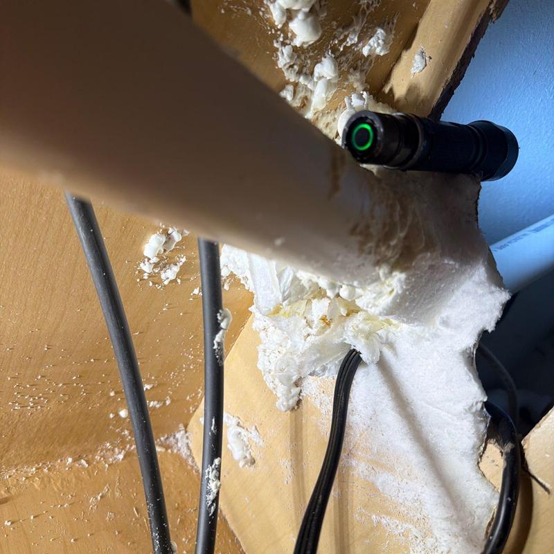 PVC pipe with sealed wall penetration and electrical cables