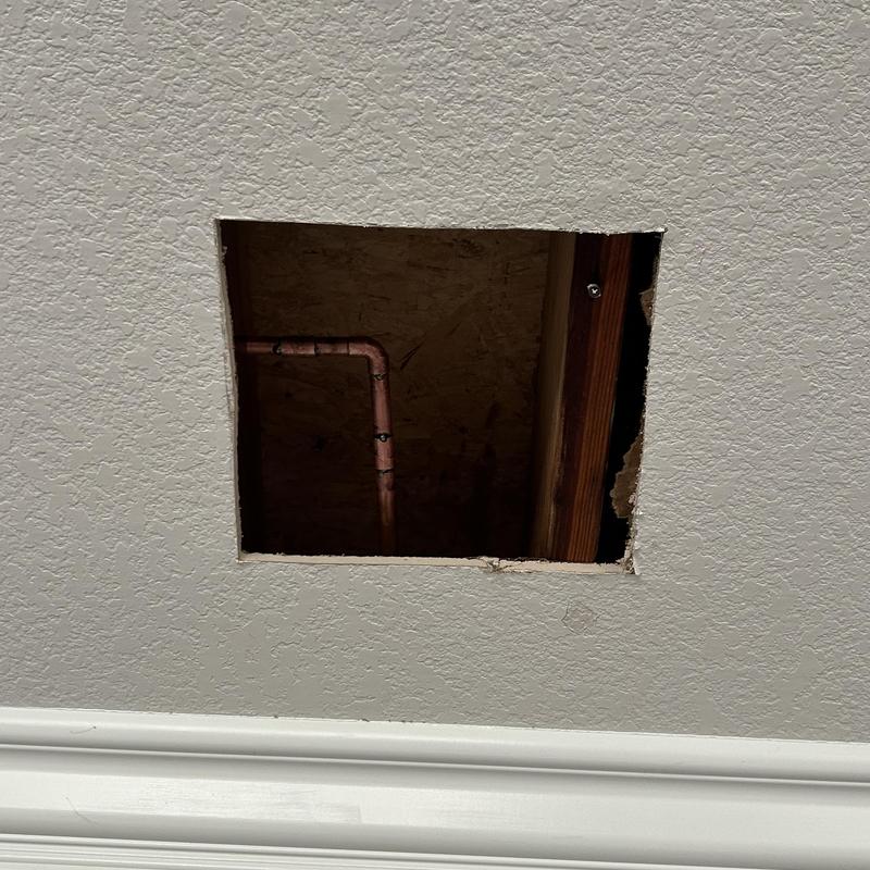 Copper plumbing pipe section removed and patched in ceiling
