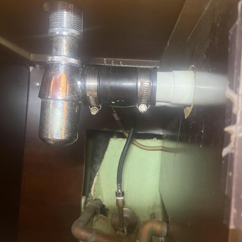 Pop-up drain pipe under bathroom sink with clamps