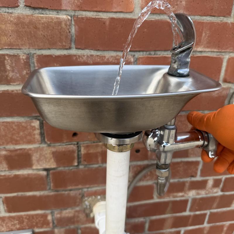 Drinking fountain water flow with gloved hand valve