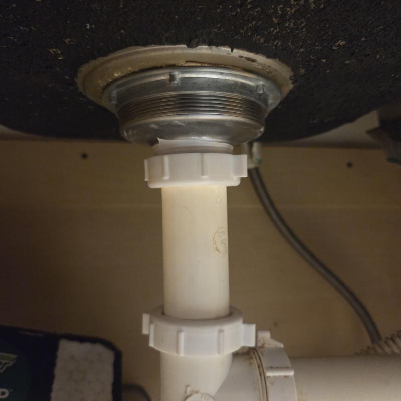 Sink drain assembly under kitchen faucet connection