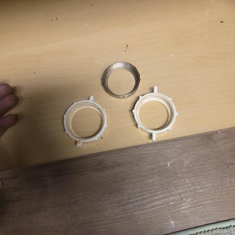 Faucet gasket and retaining rings on wood surface