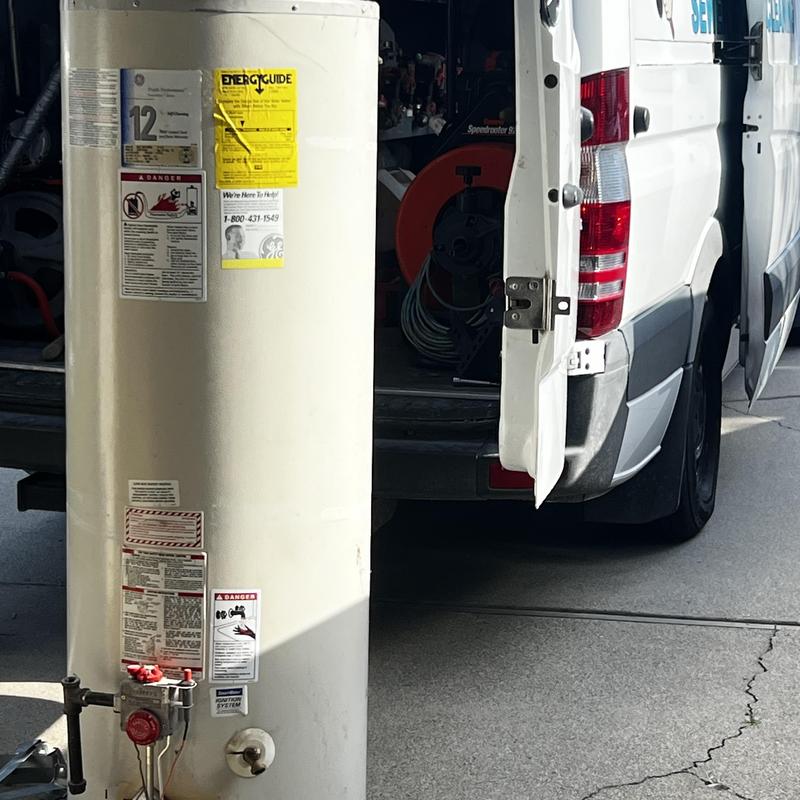 Water heater with gas valve next to service van door open
