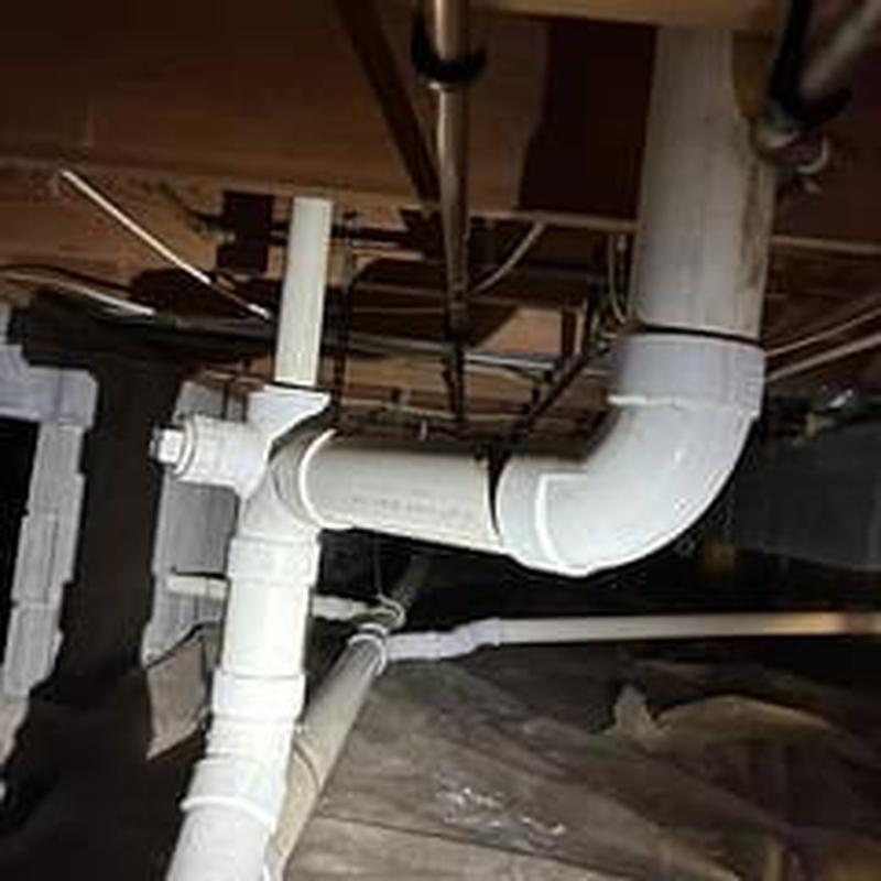 PVC drain pipes in crawl space plumbing system