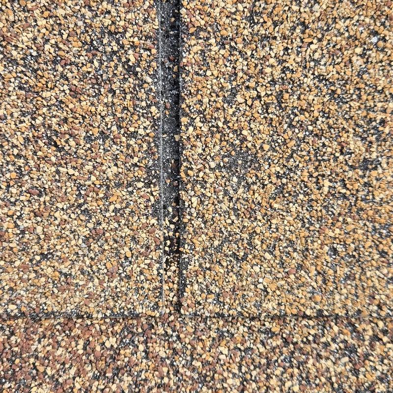 Asphalt shingle roof with hail damage close-up