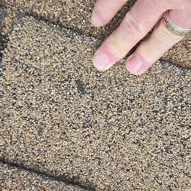 Roof shingles with hail damage inspection close-up