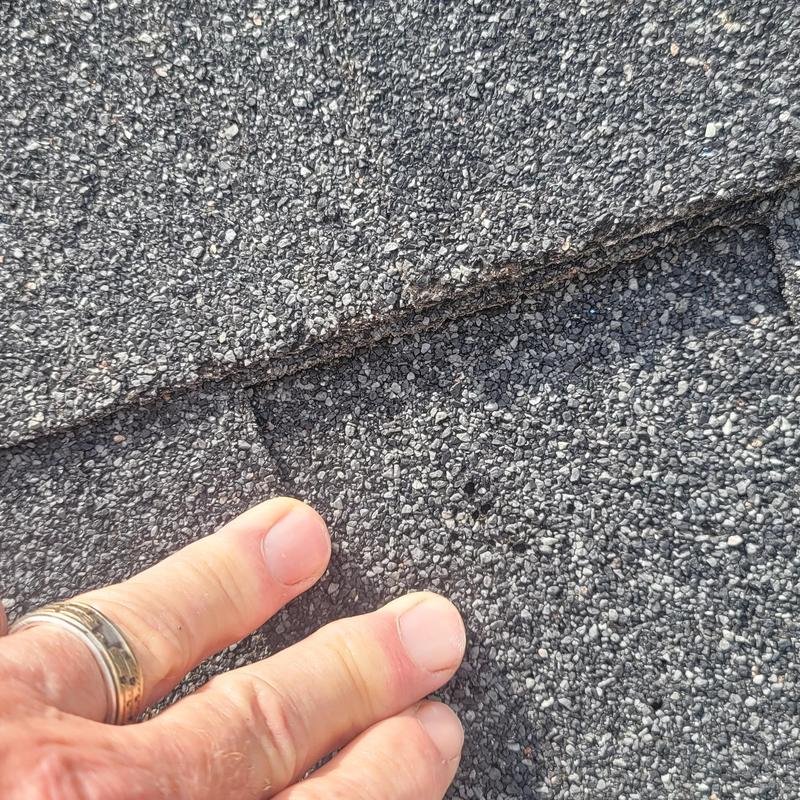 Asphalt shingle roof showing hail damage close-up