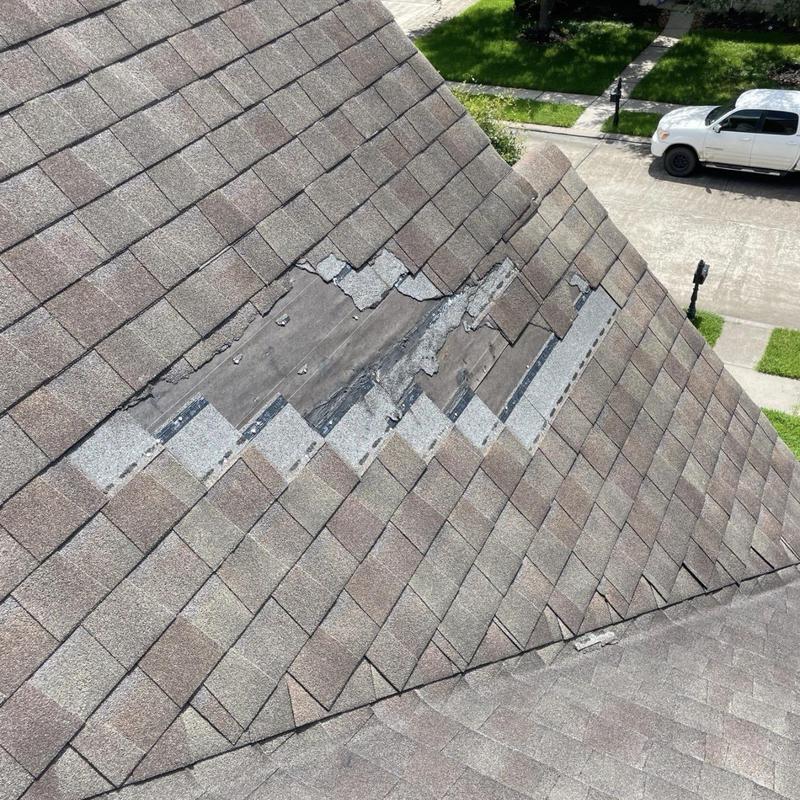 Asphalt shingle roof with damaged and missing shingles