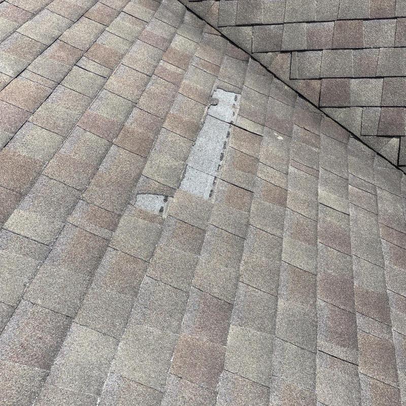 Asphalt shingles with missing and damaged areas